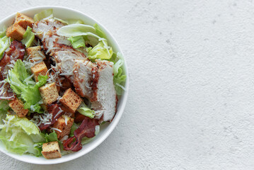 A bowl  of  Caesar salad