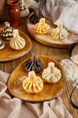 Assorted Khinkali Dumplings on Rustic Wooden Plates with Dough and Ingredients