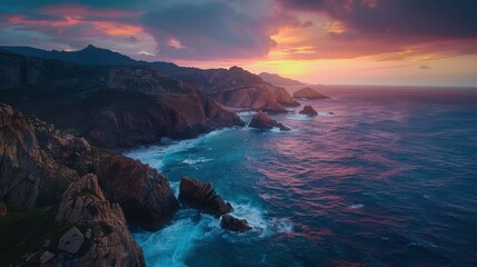 Dramatic Drone Timelapse Showcases the Rugged Beauty of a Rocky Coastline at Dawn as the Sky Transitions from Dark to Vibrant Shades of Orange and Pink