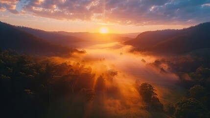 Fototapeta premium Drone timelapse footage showcasing the serene and tranquil landscape of a mountain valley during the golden hour of sunrise The mist rolls over the valley