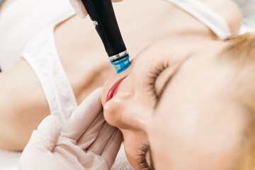 A professional performs a hydropeeling facial treatment on a woman in a modern clinic, focusing on deep skin cleansing and rejuvenation. Perfect for showcasing advanced skincare techniques.