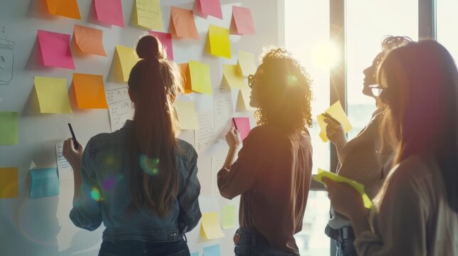 A group of professionals engaging in a brainstorming session with colorful sticky notes and sunlight streaming in through the windows, fostering creativity and innovation.