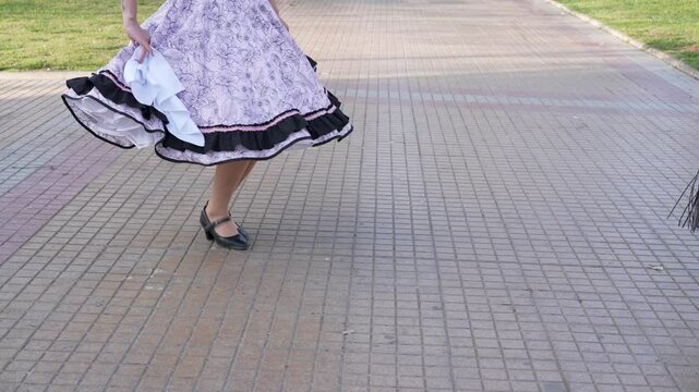 View of feet of a couple of huasos tapping their feet dancing cueca outside, concept of celebrating national holidays