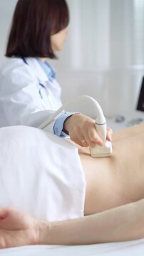 Doctor performing ultrasound examination on patient's back