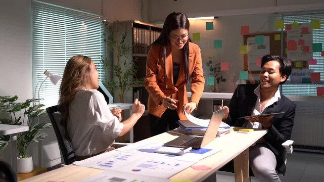 Two female ux designers are working together on a mobile app interface, arranging and rearranging paper prototypes on a table