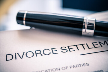 Detailed Divorce Settlement Agreement with a Silver Pen and Focus on Legal Documentation Process for Separation