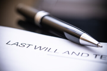 Last Will and Testament Document Close-Up with Elegant Pen on Black Background for Legal and Estate Planning Purposes