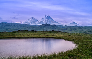 View to Klyuchevskaya Sopka and Bezymyanny volcano in Kamchatka Peninsula in Russia.