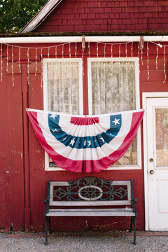 Red house with American flag design in front