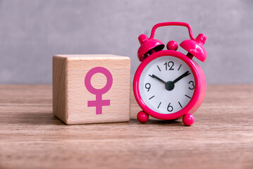 Menopause concept. Women symbol over a watch. Healthcare and medical for women. 