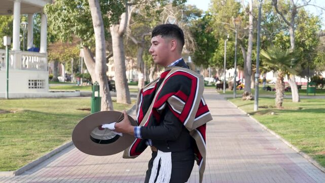 pareja de huasos bailando cueca chilena en la plaza de la ciudad