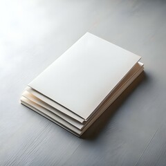A clean and simple mock up of a stack of blank brochures or flyers on a light wood table.