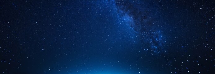 man standing on hill looking at the stars