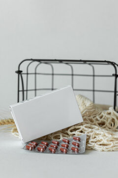 White box with pills on table