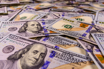 Background of one hundred dollar banknotes. Selective focus