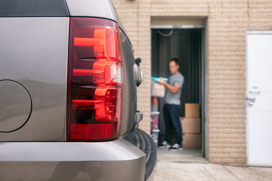Storage: Man Stacking Up Boxes In Background