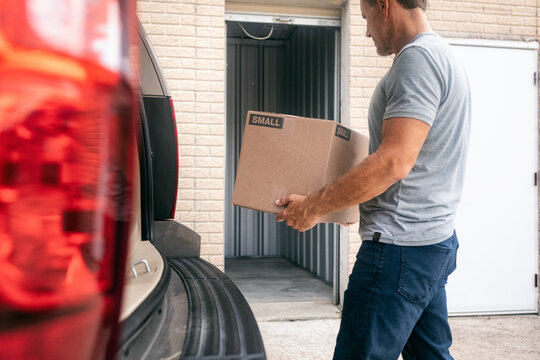 Storage: Man Carrying Box To Empty Unit