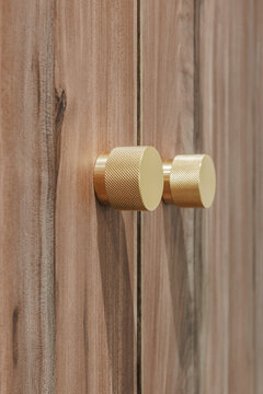 Close-up of two round, gold-colored metal knobs