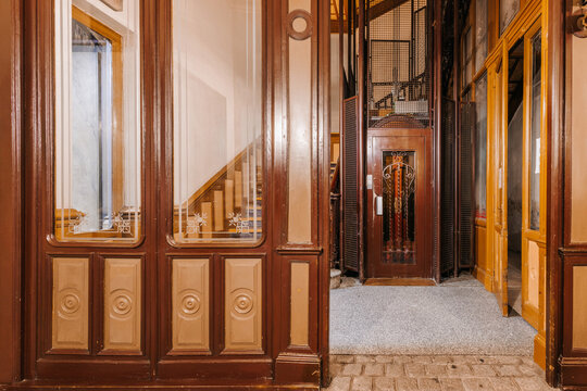A vintage elevator with ornate metal doors 
