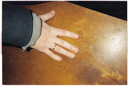 Anonymous male right hand in wood table 