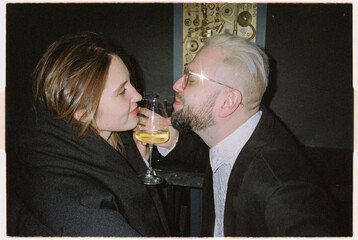 Stylish passionate couple toasting 