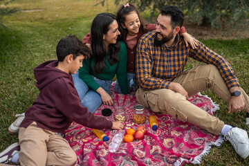 family on a picnic in a natural setting on the outskirts of the city