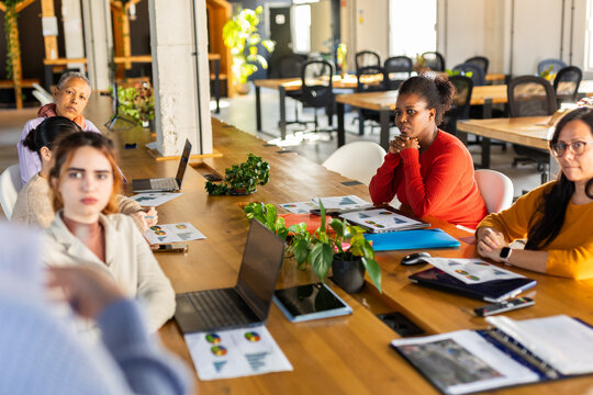 WOMAN IN A COMPANY GIVING A SALES SUMMARY