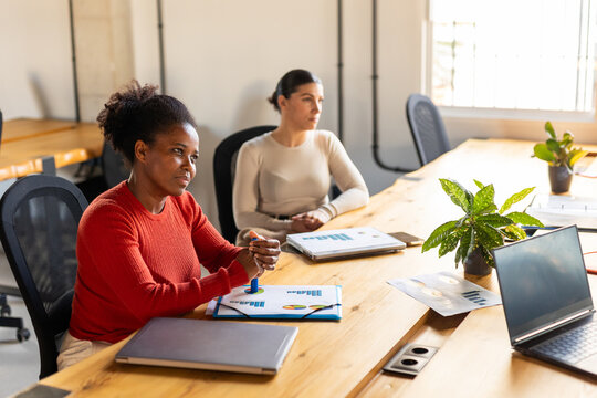 COMPANY OF WOMEN GETTING TOGETHER IN A COWORKING