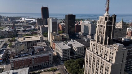 Fototapeta premium Living and working in Buffalo, New York, City skyline with office towers parks, by Lake Erie on sunny summer morning in old American City