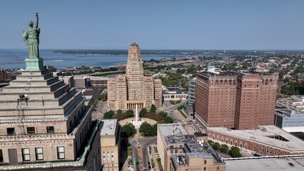 Downtown Buffalo, NY with Buffalo City Hall, office towers in morning sunshine traffic on streets below Liberty Building Art deco architecture