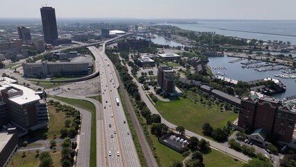 Traffic with cars and truck traveling on interstate highway through Buffalo, New York City by Lake Erie