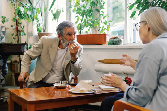Senior couple talking, resting and spending time together in cafe