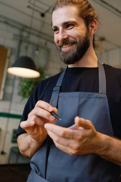 Bottom view of waiter taking order from unknown client in blurred cafe