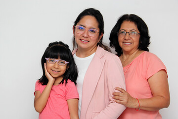 Brunette Latina grandmother, mom and daughter with glasses show their love and support together and...