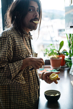Handsome young man eating an apple 