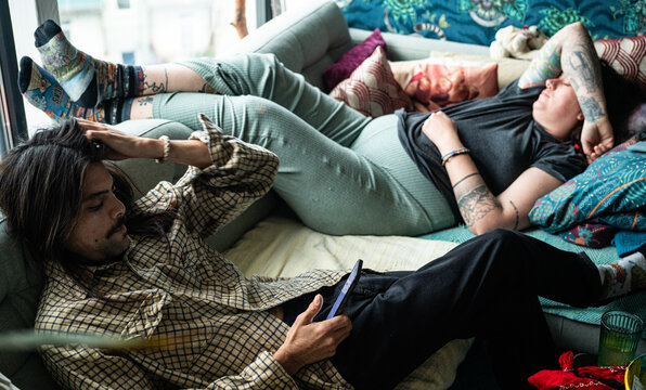 Two young people resting on couch