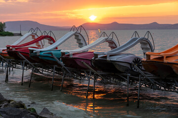 many pedal boats at sunset on lake Balaton