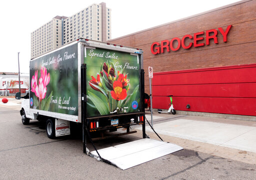 Florist from the Busch Flower Farm delivering flowers from a beautifully designed truck to sell in Target. St Paul Minnesota MN USA
