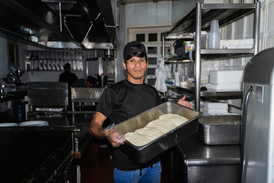 A chef in a restaurant with a tray of guayan&eacute;s cheese
