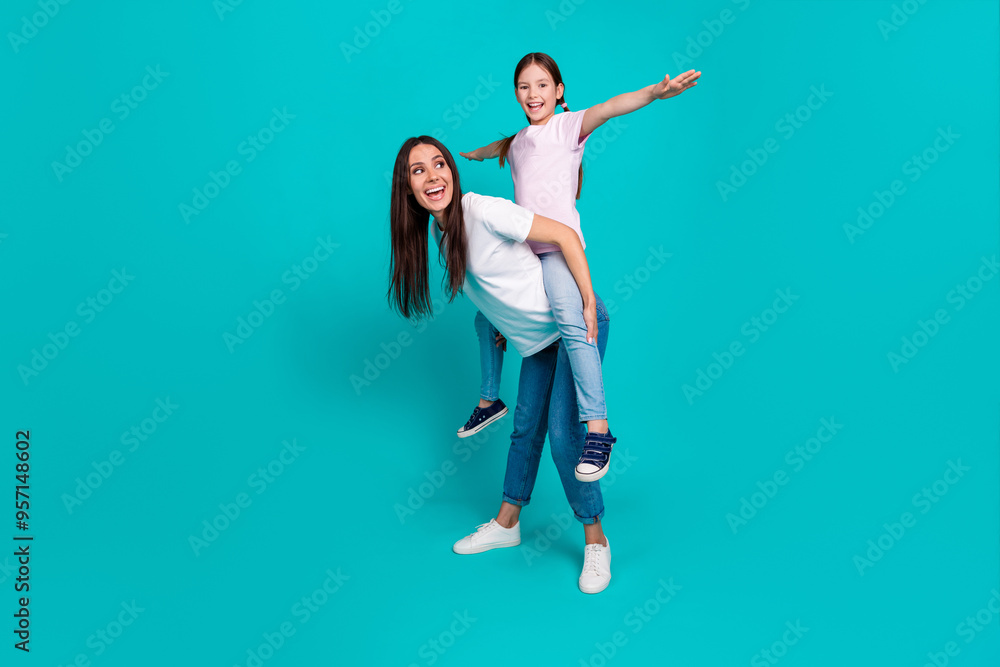 Wall mural Photo of optimistic cheerful little girl with mommy have fun wear white stylish clothes isolated on cyan color background