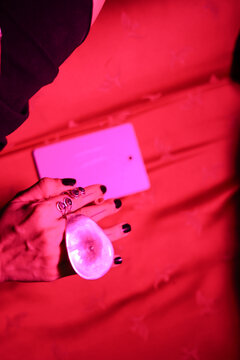 Female hand with black nails wearing stylish rings at party context