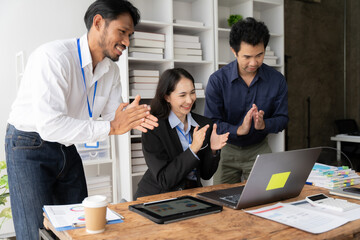 Virtual Celebration: A jubilant business team applauds a successful online presentation, highlighting the power of remote collaboration and digital communication in the modern workplace. 