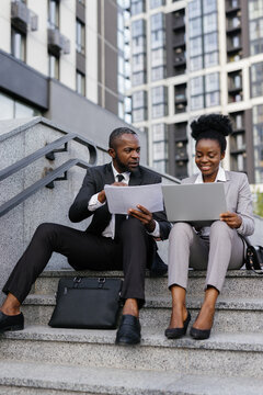 Boss dictating data from documents to employee