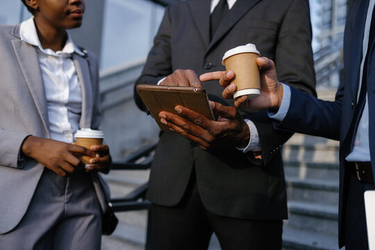 Employee pointing at something on tablet in company manager hands