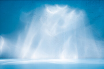 Abstract light blue background for product presentation. Light and shadow on plaster wall.	
