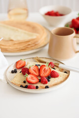 French homemade pancake crepes with strawberries. Summer breakfast. Front view