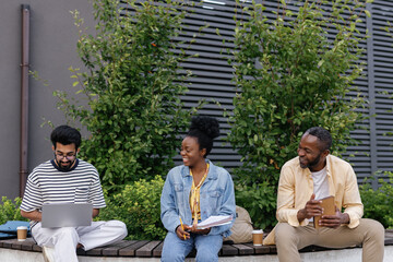 Programmer working on laptop in presence of manager and secretary