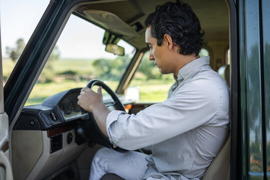 young man getting into his car to go on a trip