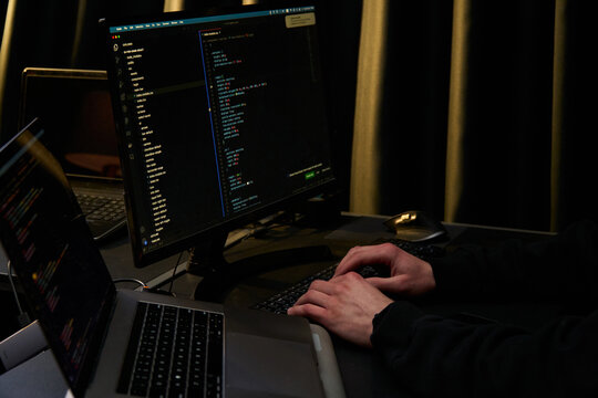  Software Developer Coding on Multiple Screens