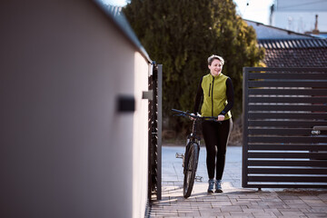 Woman Walking Next to Bike Arriving To Home